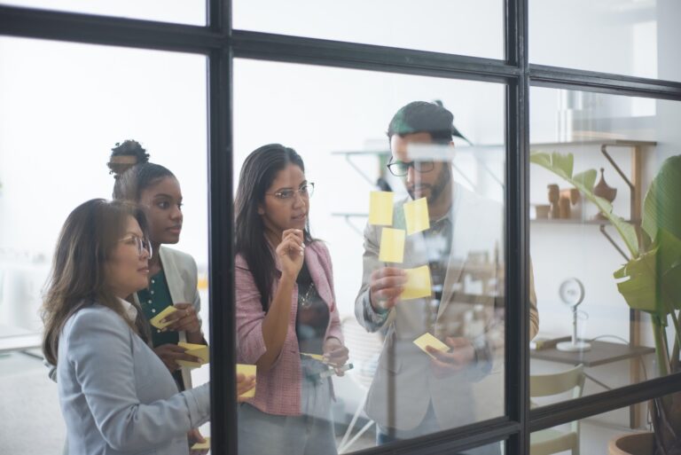 People putting stickies on glass